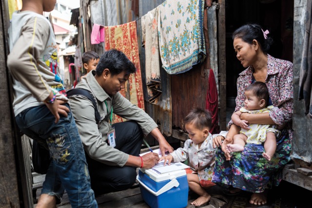 Brick by Brick report cover image: Health worker with family receiving vaccines